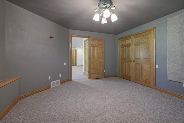 unfurnished bedroom with carpet floors, baseboards, and a closet