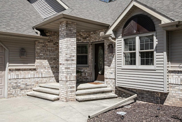 doorway to property with roof with shingles