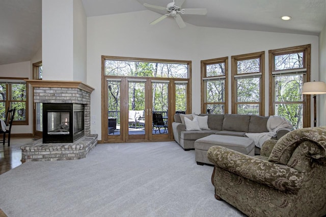 living area featuring a brick fireplace, carpet flooring, ceiling fan, high vaulted ceiling, and recessed lighting