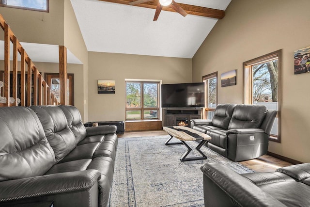 416 Sommers St, Stevens Point, WI 54481 - living area featuring high vaulted ceiling, wood finished floors, ceiling fan, beam ceiling, and stairway