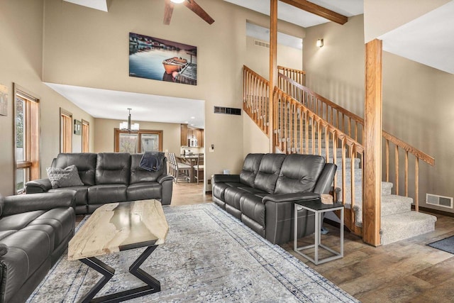 416 Sommers St, Stevens Point, WI 54481 - living area featuring wood finished floors, a chandelier, stairs, a towering ceiling, and a ceiling fan