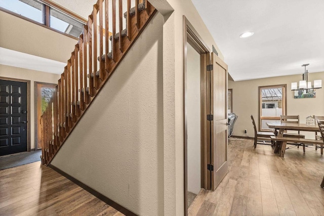 416 Sommers St, Stevens Point, WI 54481 - staircase featuring wood-type flooring, a chandelier, baseboards, and recessed lighting