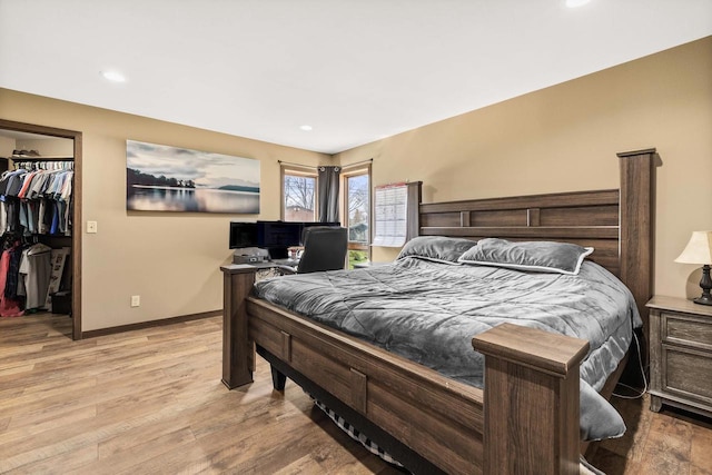 416 Sommers St, Stevens Point, WI 54481 - bedroom with a spacious closet, light wood-style floors, recessed lighting, a closet, and baseboards