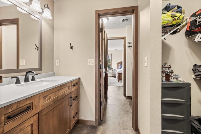416 Sommers St, Stevens Point, WI 54481 - bathroom featuring vanity, tile patterned flooring, and a textured ceiling