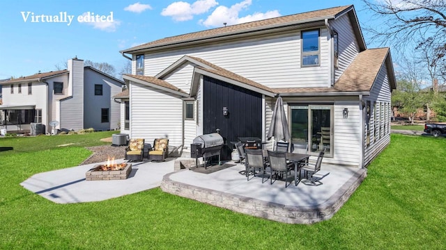 416 Sommers St, Stevens Point, WI 54481 - back of house with an outdoor fire pit, a patio area, and a lawn