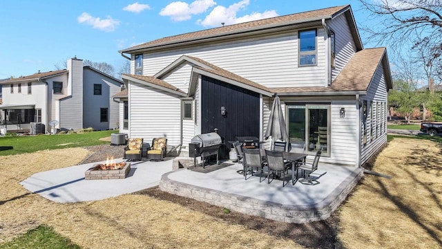 416 Sommers St, Stevens Point, WI 54481 - back of property with an outdoor fire pit, a patio, central AC, a yard, and roof with shingles