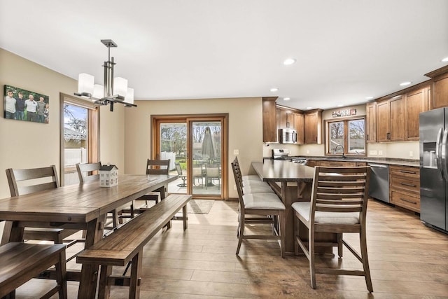 416 Sommers St, Stevens Point, WI 54481 - dining room with light wood-type flooring, plenty of natural light, recessed lighting, and a chandelier