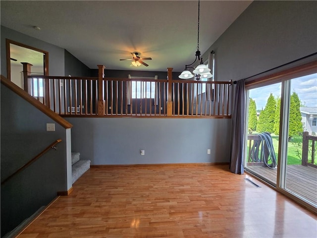13570 42nd Ave, Chippewa Falls, WI 54729 - empty room with ceiling fan, wood finished floors, plenty of natural light, and stairway