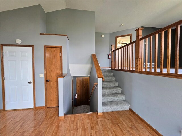 13570 42nd Ave, Chippewa Falls, WI 54729 - staircase with wood finished floors, baseboards, a ceiling fan, and lofted ceiling