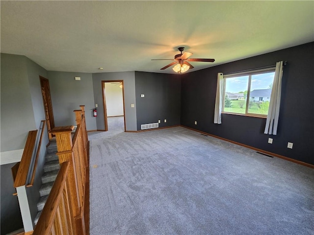 13570 42nd Ave, Chippewa Falls, WI 54729 - spare room with a ceiling fan, carpet flooring, baseboards, and stairway