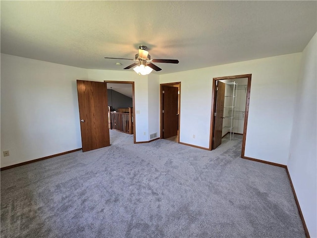 13570 42nd Ave, Chippewa Falls, WI 54729 - unfurnished bedroom with baseboards, carpet, a walk in closet, and ceiling fan