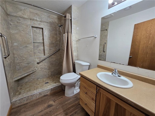 13570 42nd Ave, Chippewa Falls, WI 54729 - full bathroom with wood finished floors, tiled shower, toilet, and vanity