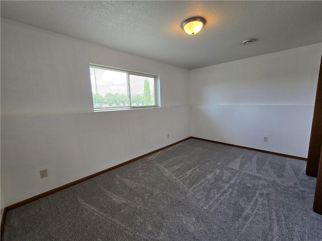13570 42nd Ave, Chippewa Falls, WI 54729 - unfurnished room featuring dark colored carpet, baseboards, and a textured ceiling