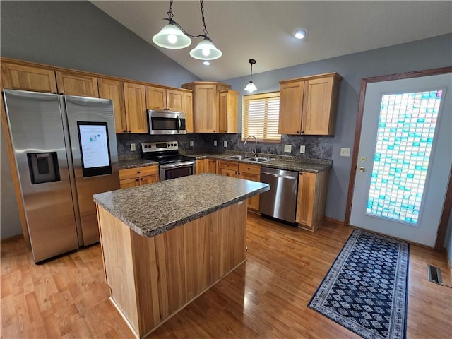 13570 42nd Ave, Chippewa Falls, WI 54729 - kitchen featuring appliances with stainless steel finishes, a sink, light wood-style floors, dark countertops, and lofted ceiling
