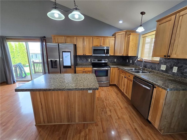 13570 42nd Ave, Chippewa Falls, WI 54729 - kitchen with appliances with stainless steel finishes, a sink, a center island, light wood-type flooring, and high vaulted ceiling