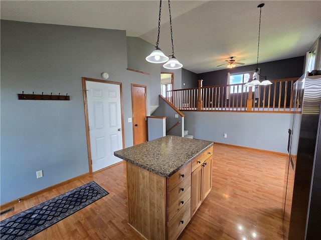 13570 42nd Ave, Chippewa Falls, WI 54729 - kitchen featuring a ceiling fan, light wood finished floors, baseboards, a center island, and high vaulted ceiling