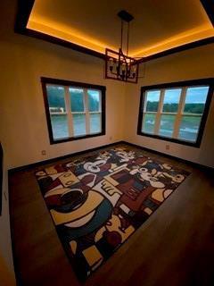 20398 64th Ave, Chippewa Falls, WI 54729 - spare room featuring a tray ceiling and a chandelier