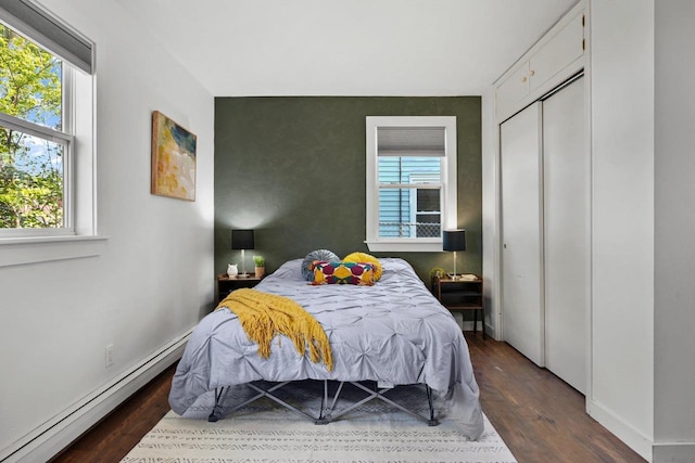 3486 Hargrove St, Madison, WI 53714 - bedroom featuring baseboard heating, dark wood-style floors, and multiple windows