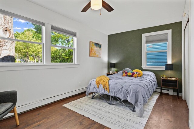3486 Hargrove St, Madison, WI 53714 - bedroom with a baseboard radiator, multiple windows, wood finished floors, and baseboard heating