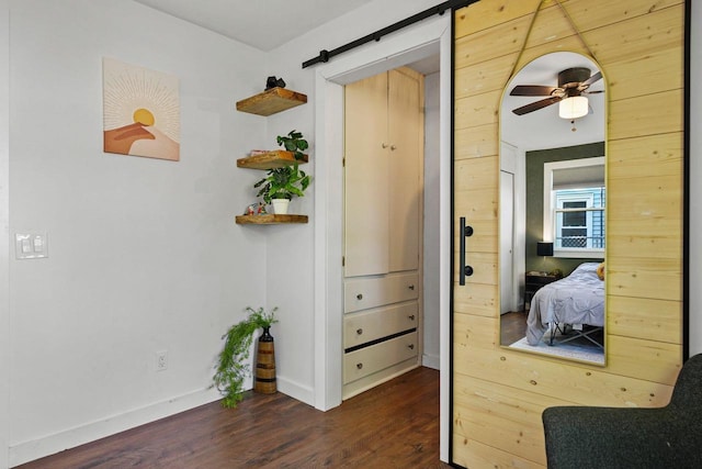 3486 Hargrove St, Madison, WI 53714 - bedroom with dark wood finished floors, a barn door, and baseboards