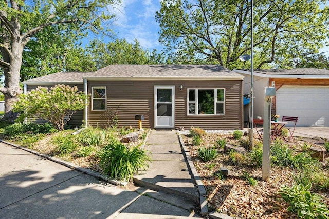3486 Hargrove St, Madison, WI 53714 - view of front of property featuring an attached garage, roof with shingles, and concrete driveway