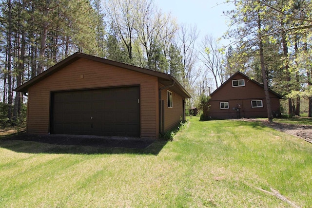 N9394 21st Ave, Neshkoro, WI 54960 - view of side of home with a detached garage, an outbuilding, and a lawn