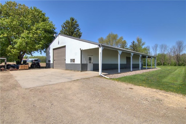 N492 County Road D, Eau Galle, WI 54737 - view of property exterior featuring a garage, a lawn, and concrete driveway