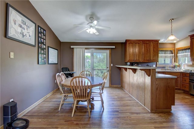 N492 County Road D, Eau Galle, WI 54737 - dining area with light wood-style floors, a ceiling fan, and baseboards
