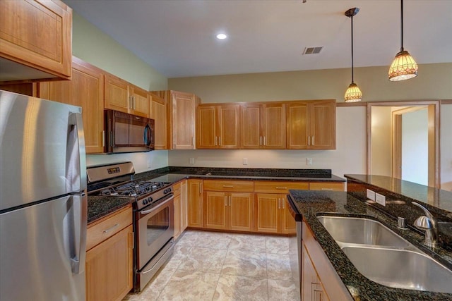 6767 Frank Lloyd Wright Ave Unit 219, Middleton, WI 53562 - kitchen featuring appliances with stainless steel finishes, a sink, pendant lighting, dark stone counters, and recessed lighting