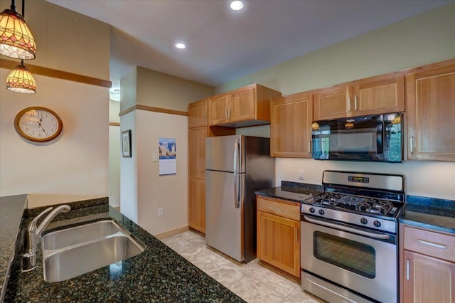 6767 Frank Lloyd Wright Ave Unit 219, Middleton, WI 53562 - kitchen with appliances with stainless steel finishes, a sink, dark stone counters, hanging light fixtures, and recessed lighting