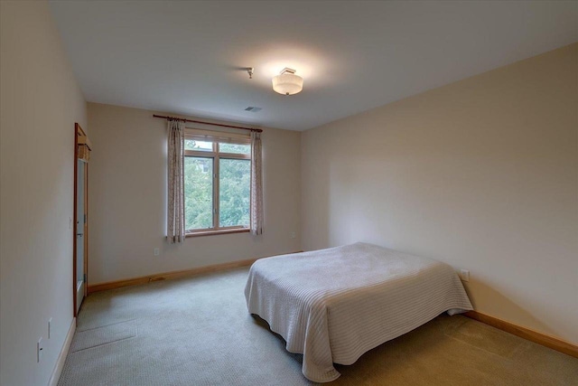 6767 Frank Lloyd Wright Ave Unit 219, Middleton, WI 53562 - bedroom featuring light carpet and baseboards