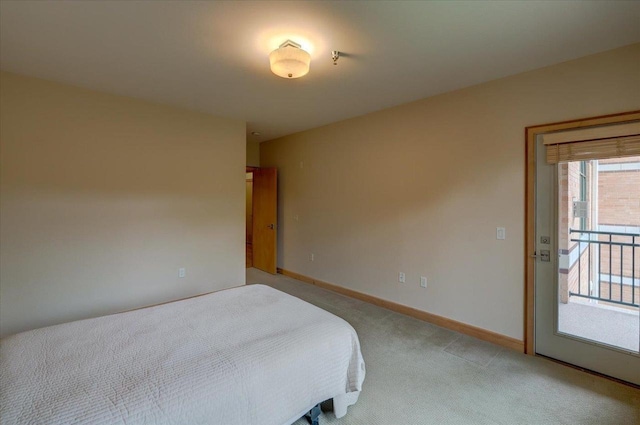 6767 Frank Lloyd Wright Ave Unit 219, Middleton, WI 53562 - bedroom featuring light colored carpet, baseboards, and access to exterior