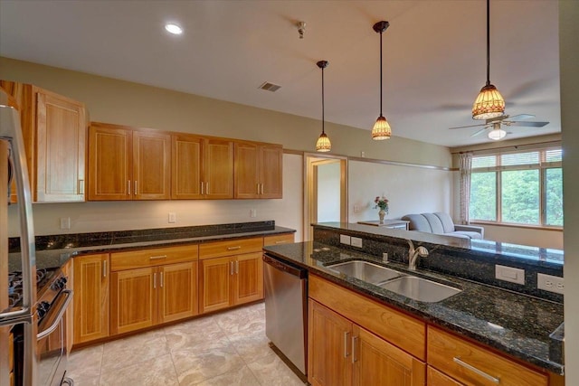 6767 Frank Lloyd Wright Ave Unit 219, Middleton, WI 53562 - kitchen with stainless steel appliances, a sink, a ceiling fan, decorative light fixtures, and dark stone countertops
