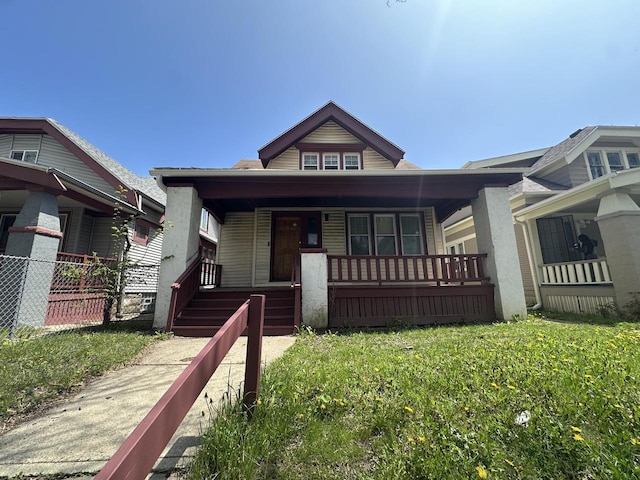 bungalow with a porch and fence