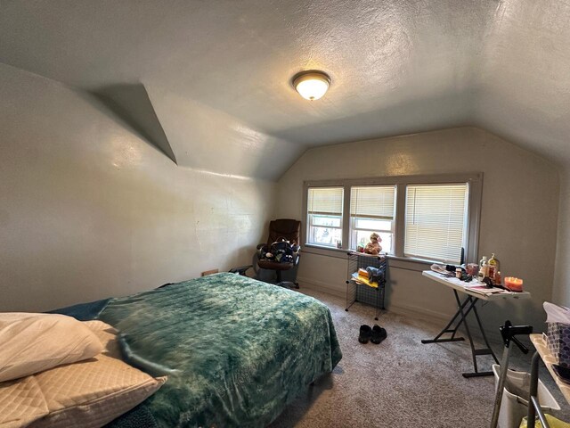 bedroom with vaulted ceiling and carpet