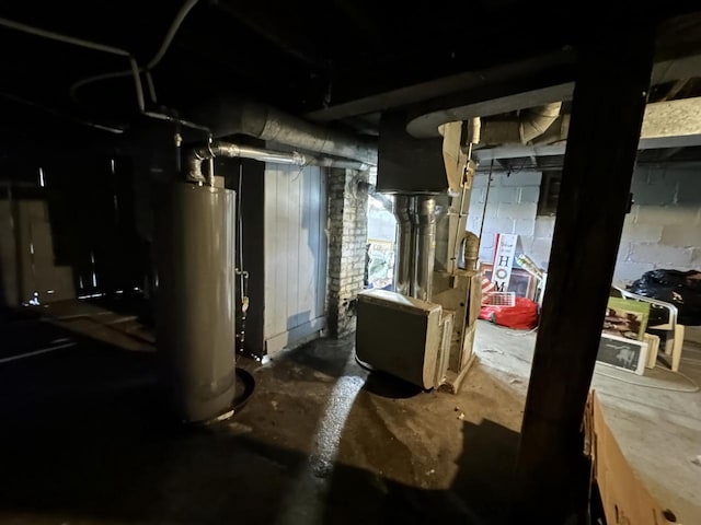 unfinished below grade area featuring water heater