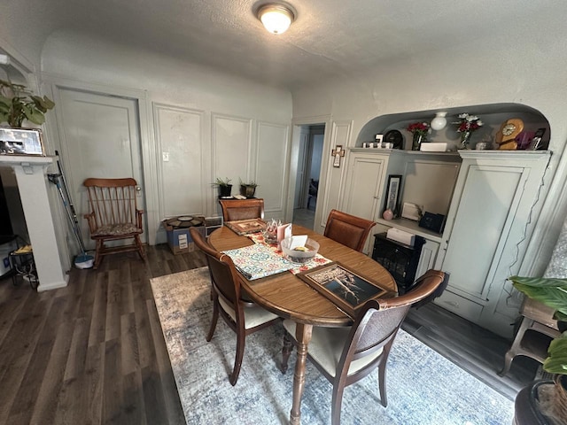 dining space featuring dark wood-style flooring