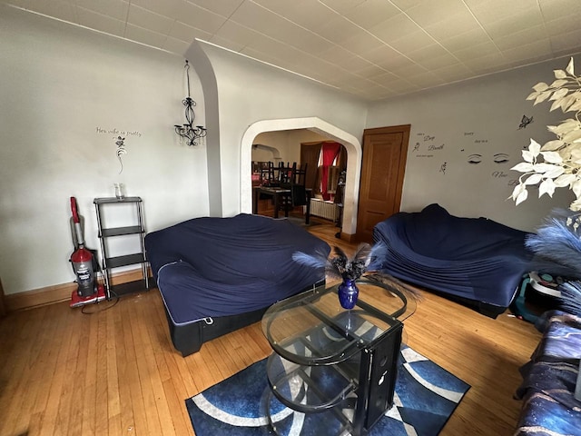 5733 W Philip Pl, Milwaukee, WI 53216 - living area with arched walkways, hardwood / wood-style floors, and radiator
