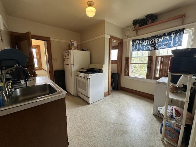 5733 W Philip Pl, Milwaukee, WI 53216 - kitchen featuring white appliances, a sink, baseboards, and light countertops