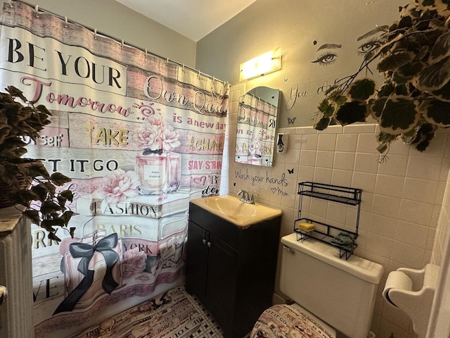 5733 W Philip Pl, Milwaukee, WI 53216 - bathroom with tile walls, toilet, vanity, a shower with shower curtain, and wainscoting