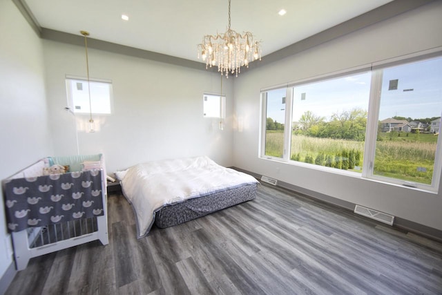 bedroom with wood finished floors, a chandelier, recessed lighting, and baseboards