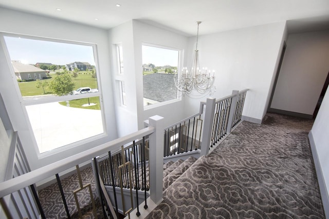 corridor featuring an upstairs landing, a chandelier, carpet floors, baseboards, and recessed lighting