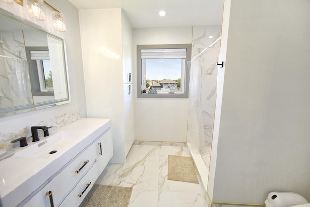 bathroom with marble finish flooring, a marble finish shower, vanity, and recessed lighting