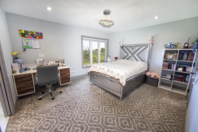 carpeted bedroom with an office area and recessed lighting