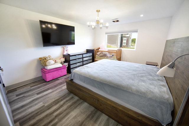 bedroom featuring a chandelier, wood finished floors, baseboards, and recessed lighting