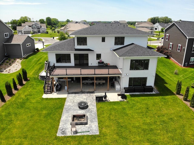back of house featuring an outdoor fire pit, stairs, a patio area, a deck, and a residential view