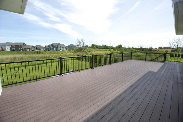 deck featuring a residential view and a lawn