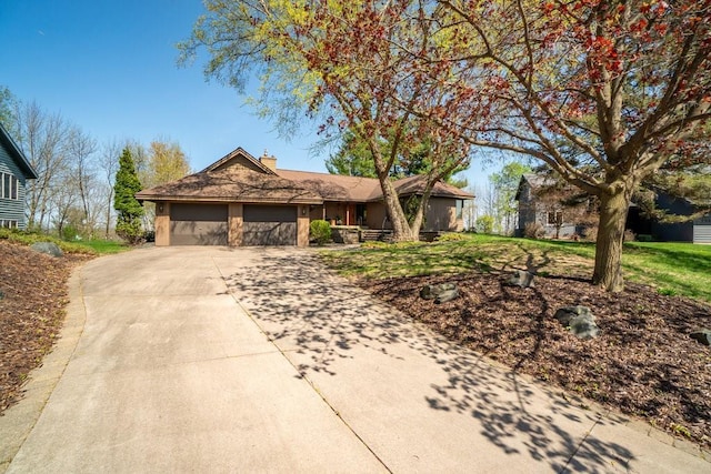 519 Grandview Heights Ct, Menomonie, WI 54751 - ranch-style house featuring a chimney, concrete driveway, an attached garage, and a front yard