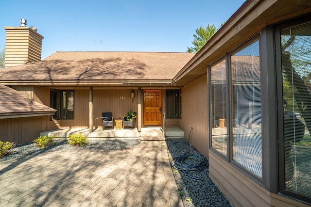 519 Grandview Heights Ct, Menomonie, WI 54751 - rear view of property with roof with shingles, a chimney, and a patio