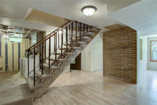 1286 Krattley Ln, Hudson, WI 54016 - stairs with washer and clothes dryer and wood finished floors
